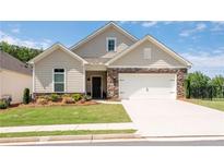 Charming single-Gathering home featuring stone accents, a two-car garage, and a beautifully landscaped front yard at 4902 Pleasantry Way, Acworth, GA 30101