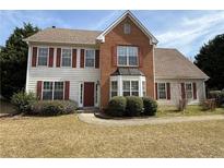 Charming two-story home features brick and siding, complemented by red shutters at 2074 Green Gate Pl, Grayson, GA 30017