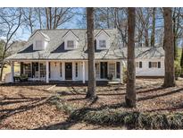 Charming two-story home with dormer windows, covered porch, and mature trees in a quiet setting at 3780 Clubview Se Ct, Conyers, GA 30094