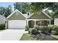 Charming home featuring an attached two car garage, landscaped front yard and inviting front porch at 8237 Eastshore Dr, Union City, GA 30291