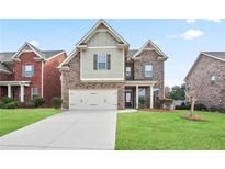 Charming two-story home with a two-car garage and well-maintained lawn at 2471 Arnold Palmer Way, Duluth, GA 30096