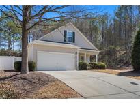 Charming single-Gathering home with a two-car garage, inviting front porch, and well-maintained landscaping at 300 W Oaks Trl, Woodstock, GA 30188