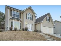 Charming two-story home featuring a two-car garage and a well-maintained front yard at 851 Louisa Ln, Lithonia, GA 30058