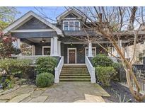 Charming two-story home with landscaped front yard, stone path and elegant porch at 289 9Th Ne St, Atlanta, GA 30309