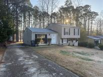 Charming split-level home featuring a well-maintained lawn and a private driveway at 2976 Nelson Dr, Duluth, GA 30096