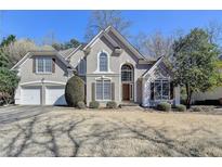 Charming two-story traditional home with a well-manicured lawn and a two-car garage in a suburban setting at 4260 River Club Dr, Cumming, GA 30041