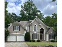 Charming traditional home featuring a two-car garage, shutters and meticulously maintained landscaping at 4260 River Club Dr, Cumming, GA 30041
