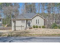 Charming home featuring a well-maintained front yard and inviting architecture at 1975 Hunt Crossing Ct, Lawrenceville, GA 30043