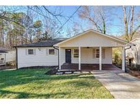 Charming single-story home with a covered front porch, manicured lawn, and a welcoming entrance at 2175 Venesa Cir, Austell, GA 30168