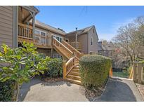 A charming exterior view featuring wooden stairs and well-maintained landscaping at 708 Mill Pond Se Dr, Smyrna, GA 30082
