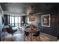 Stylish living room featuring wood floors, modern furniture, and large windows offering ample natural light at 2870 Pharr Court South Nw # 2402, Atlanta, GA 30305