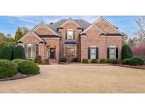 Brick two-story home with manicured landscaping and traditional architectural details at 359 Flatstone Sw Way, Marietta, GA 30064