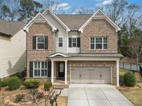 Charming brick home with a two-car garage, landscaped front yard, and elegant architectural details at 4325 Bellview Ln, Duluth, GA 30097