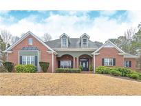 Charming red brick home with manicured landscaping and a welcoming front porch at 9445 Grande Dr, Winston, GA 30187