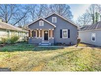 Charming one-story home featuring a welcoming front porch and well-maintained front yard at 2506 Maple St, East Point, GA 30344