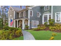 Stunning exterior of gray shingle home with a welcoming front porch and landscaped front yard at 4655 Jett Rd, Atlanta, GA 30327