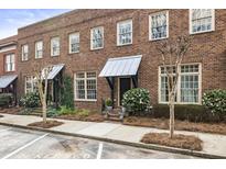 Charming brick townhomes with landscaped front yards and private entrances create a welcoming curb appeal at 5821 Clarion St # J8, Cumming, GA 30040