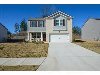 Charming two-story home featuring a two-car garage and a well-manicured front yard at 67 Highgrove Way, Dallas, GA 30157