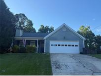 Charming single-story home featuring a well-manicured front lawn and attached two-car garage at 1007 Billy Mcgee Rd, Lawrenceville, GA 30045