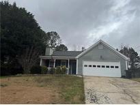 Charming single-Gathering home with a well-maintained front lawn and an attached two-car garage at 1007 Billy Mcgee Rd, Lawrenceville, GA 30045