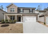 Charming two-story home with a brick and siding facade, attached garage, and well-manicured front lawn at 514 Cunninghame Ct, Peachtree City, GA 30269