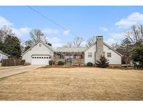 Charming single-story home with a two car garage and well-maintained lawn at 6325 S Summers S Cir, Douglasville, GA 30135