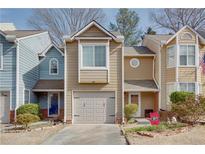 Charming townhome featuring a one-car garage, neutral colors, and inviting curb appeal at 3225 Long Iron Dr, Lawrenceville, GA 30044