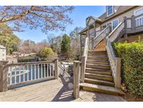 Inviting multi-level deck with stairs overlooking lush greenery and a serene water feature at 504 Mill Pond Ct, Smyrna, GA 30082