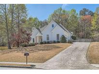 Beautiful single Gathering home boasting mature landscaping, a concrete drive, and neutral exterior at 3619 Elinburg Ne Ct, Buford, GA 30519