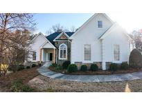 Beautiful home with stone accents, a curved walkway, and manicured landscaping at 3619 Elinburg Ne Ct, Buford, GA 30519