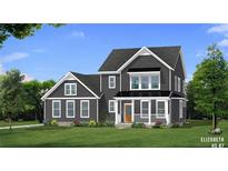 Charming two-story home featuring a covered porch, gray siding and manicured lawn at 4041 Andover Cir, Mcdonough, GA 30252