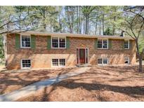 Charming two-story brick home with green shutters and a well-manicured front yard at 410 Killian Hill Sw Rd, Lilburn, GA 30047
