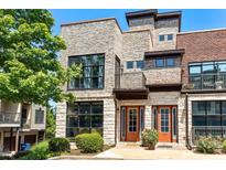 Stunning townhouse with a stone facade, large windows, and a welcoming entrance at 1199 Huff Rd # 121, Atlanta, GA 30318