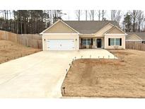 Charming single-story home with a well-manicured lawn, a two-car garage, and a welcoming front porch at 127 Cranbrooke Dr, Dallas, GA 30157