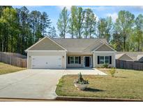 Inviting single-story home with a two-car garage and a charming front yard at 127 Cranbrooke Dr, Dallas, GA 30157