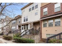 Charming multi-story townhomes with stone and brick accents and well-maintained front landscaping at 3066 Quantum Ln # 24, Atlanta, GA 30341