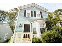 Charming two-story home featuring light blue siding, black shutters, and a well-manicured front yard at 755 Heritage Valley Rd, Norcross, GA 30093
