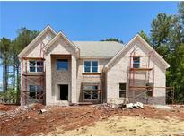 New two-story brick home under construction features large windows and a classic gable roof design at 254 Lotus Ln, Covington, GA 30016