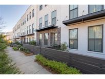 Charming townhome row with attractive exterior design, manicured landscaping, and sidewalk at 852 Constellation Dr, Decatur, GA 30033