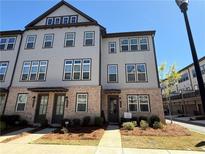 Attractive townhome features gray siding, brick accents, and a welcoming front entrance at 3987 Allegretto Cir # 250, Atlanta, GA 30339