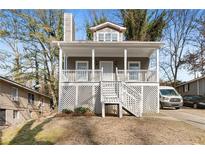 Charming home featuring a cozy front porch and inviting curb appeal at 1477 Akridge Nw St, Atlanta, GA 30314