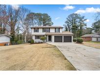 Charming two-story home featuring a two-car garage and well-maintained landscaping, perfect for suburban living at 2167 Cedar Dr, Lawrenceville, GA 30043