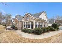Charming brick home featuring large windows, manicured landscaping, and inviting curb appeal at 4809 Shae Ct, Powder Springs, GA 30127