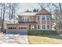 Charming two-story home with a two-car garage and well-maintained landscaping and neutral color palette at 4852 Gold Nugget Way, Sugar Hill, GA 30518