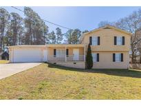 Charming two-story home featuring a spacious front yard and attached garage, perfect for Gathering living at 774 Marthas Dr, Lawrenceville, GA 30045