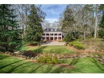 Stately brick home with large columns, mature trees, and a well-manicured lawn at 0 Winterthur, Sandy Springs, GA 30328