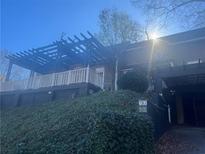 Home exterior boasting a pergola, lush landscaping, and dark paint at 294 Hascall Nw Rd, Atlanta, GA 30309