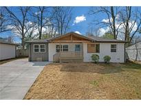 Charming single-story home with a welcoming front porch and modern exterior paint scheme at 3235 Bluebird Ln, Decatur, GA 30032