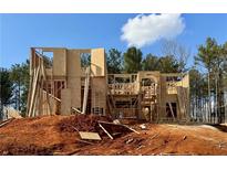 New home under construction showcasing wood framing and modern design on a spacious lot at 206 Lotus Ln, Covington, GA 30016
