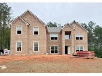 New two-story brick home featuring classic architectural elements and a traditional design at 218 Lotus Ln, Covington, GA 30016